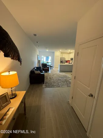 a living room with furniture a rug and a flat screen tv