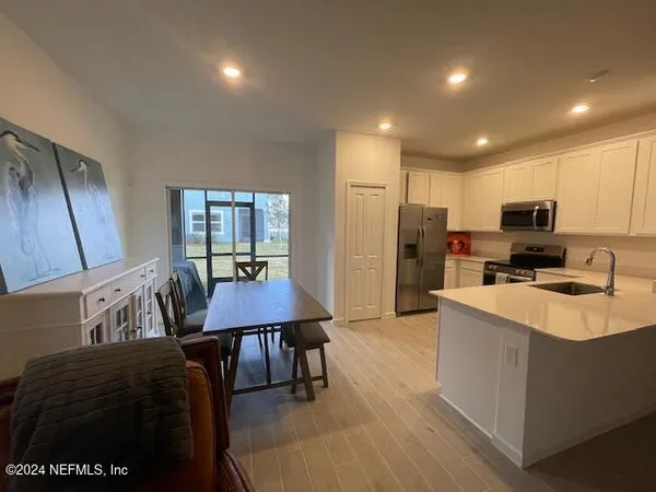 a living room with furniture and a air conditioner vent