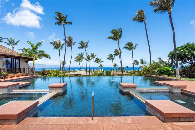 a living room with fireplace furniture and a large window