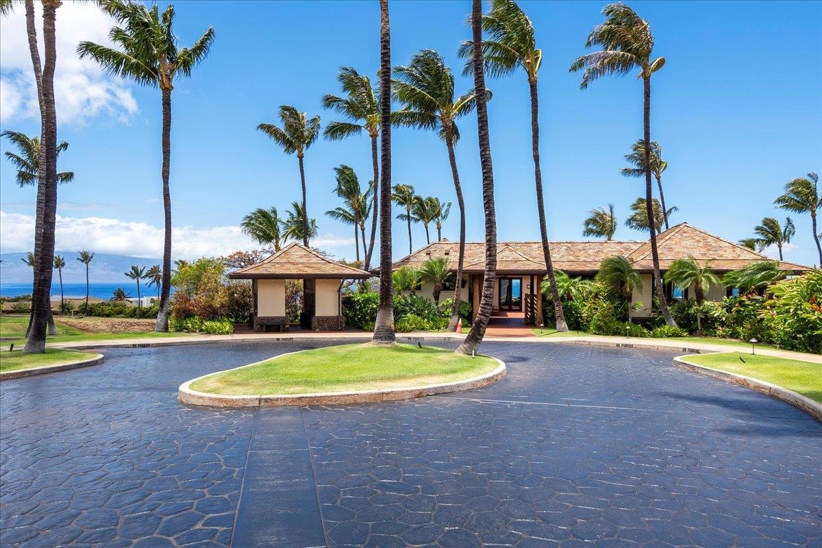4 Anapuni Loop Lahaina, HI 96761 - Photo 31 of 44 a view of a swimming pool with a yard and palm trees