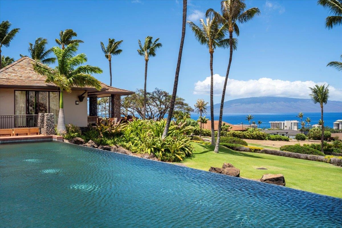 4 Anapuni Loop Lahaina, HI 96761 - Photo 4 of 44 a view of a house with swimming pool lawn chairs and a yard