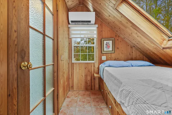 a bedroom with a bed and a window