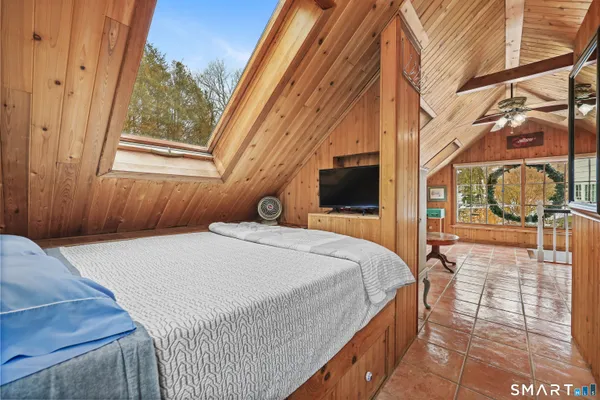 a bedroom with a bed and a window