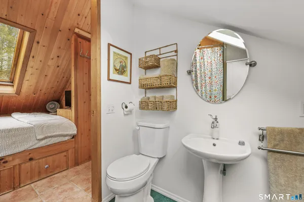 a bathroom with a toilet sink and mirror