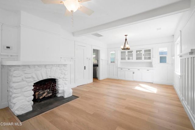a view of empty room with a fireplace and chandelier