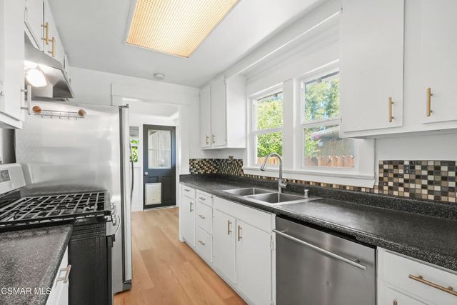 a kitchen with a sink stove and window