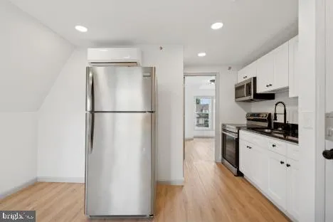 a kitchen with stainless steel appliances a refrigerator sink and microwave