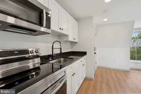 a kitchen with granite countertop a stove and a sink