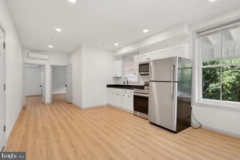 a kitchen with a refrigerator and a stove top oven