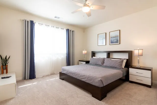 a bedroom with a bed and a chandelier