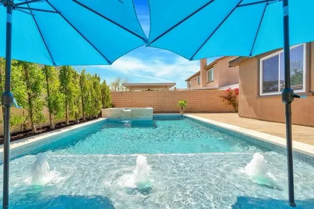 a living room with furniture a flat screen tv and a kitchen