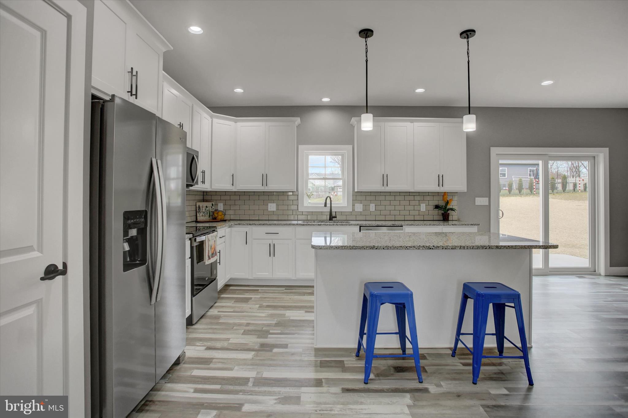 67 James Way Greencastle, PA 17225 - Photo 11 of 41 a kitchen with stainless steel appliances granite countertop a refrigerator a sink dishwasher a stove and white cabinets with wooden floor