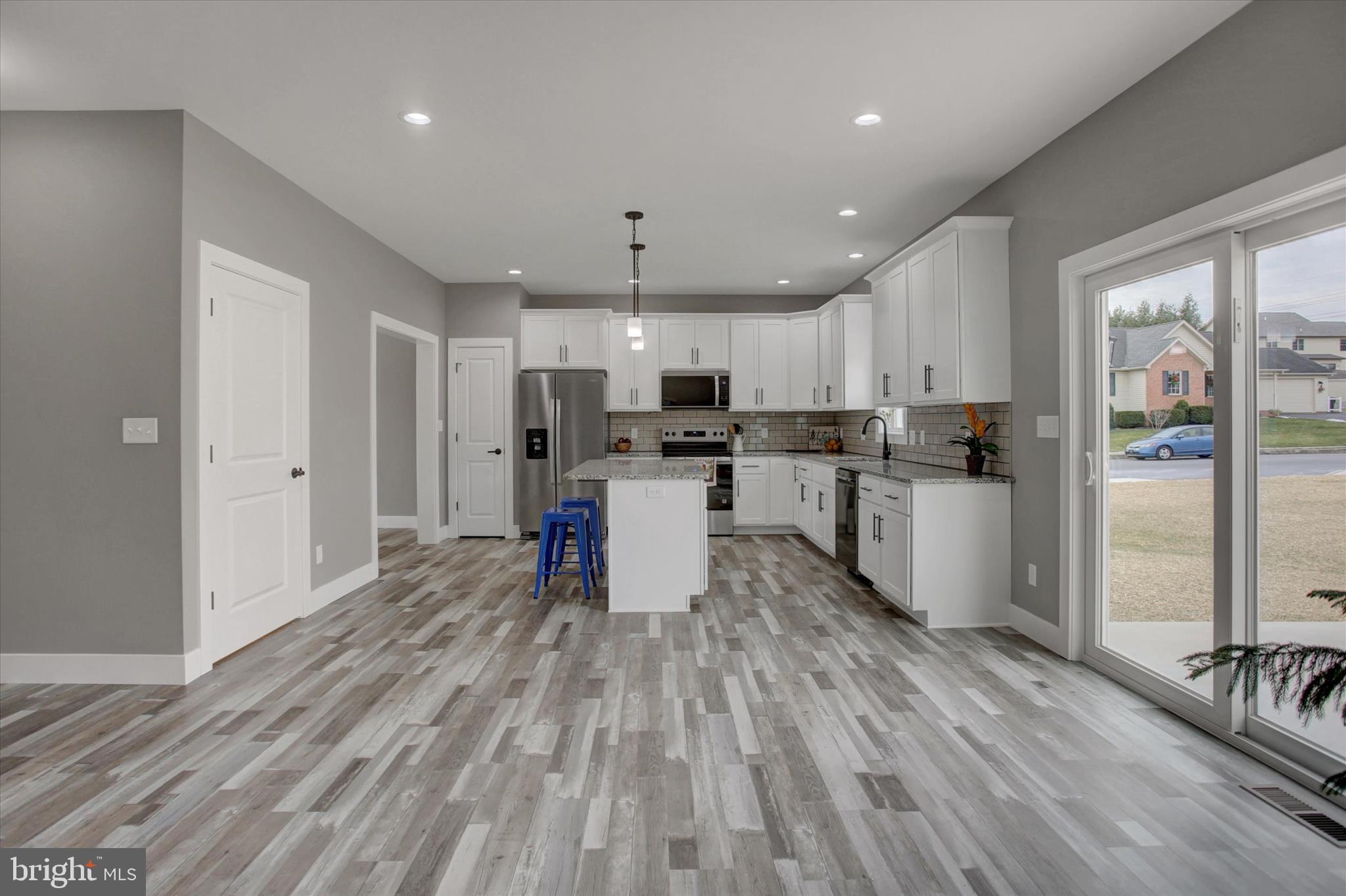 67 James Way Greencastle, PA 17225 - Photo 20 of 41 a kitchen with stainless steel appliances granite countertop a refrigerator oven a sink dishwasher and white cabinets with wooden floor