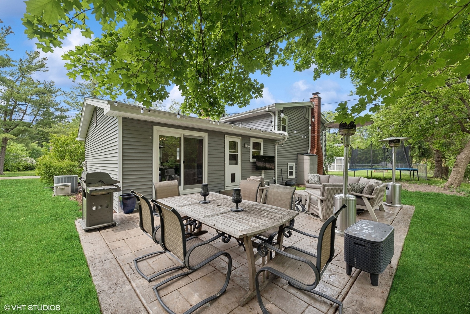 1200 Arbor Vitae Road Deerfield, IL 60015 - Photo 21 of 27 a view of a patio with table and chairs and a large tree