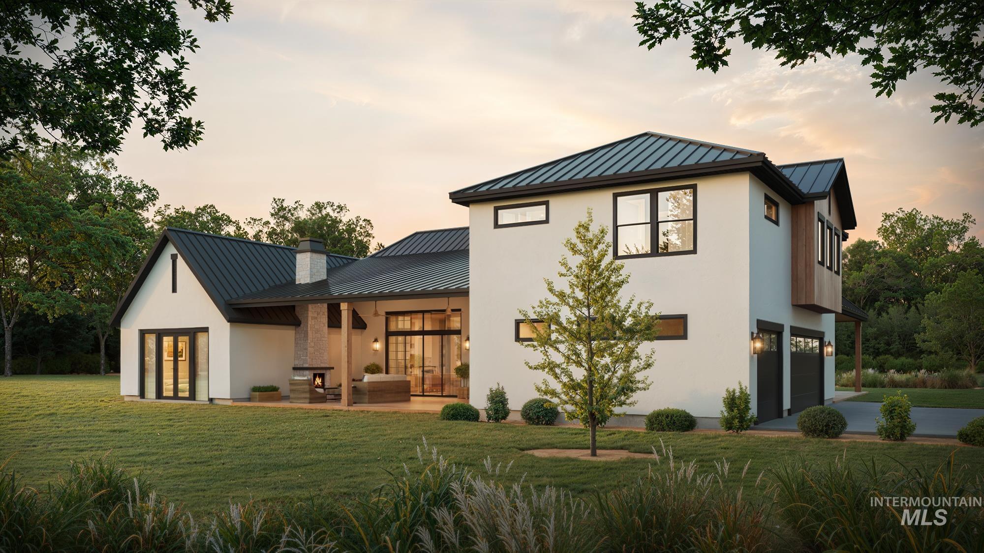 Tbd Tbd Tbd Cabernet Lane Caldwell, ID 83607 - Photo 2 of 20 Back of house at dusk with a standing seam roof, a lawn, a garage, and stucco siding