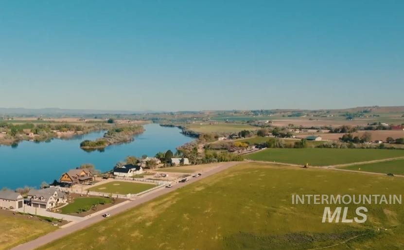 Tbd Tbd Tbd Cabernet Lane Caldwell, ID 83607 - Photo 6 of 23 Aerial perspective showcasing a waterfront property with established residences and expansive green fields