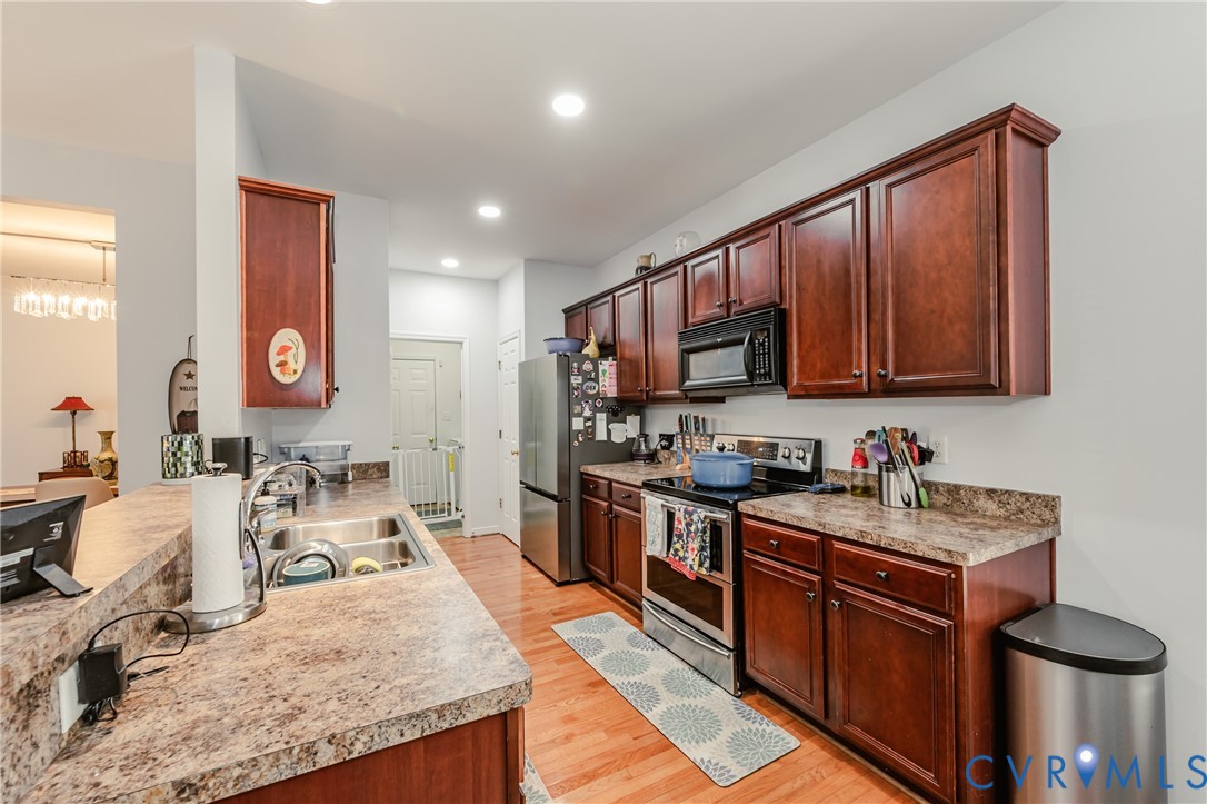 1113 Alcorn Terrace Midlothian, VA 23114 - Photo 22 of 44 a kitchen with wooden cabinets and a sink