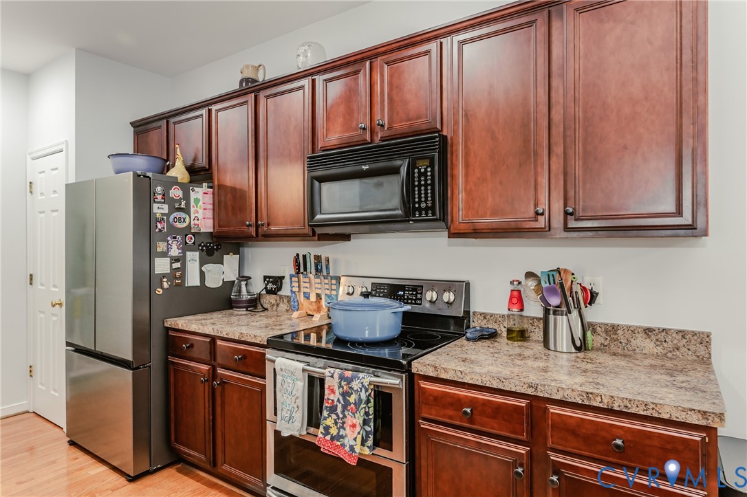 1113 Alcorn Terrace Midlothian, VA 23114 - Photo 23 of 44 a kitchen with stainless steel appliances granite countertop a refrigerator stove and microwave