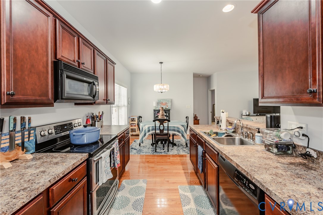 1113 Alcorn Terrace Midlothian, VA 23114 - Photo 27 of 44 a kitchen with granite countertop a sink stove and cabinets