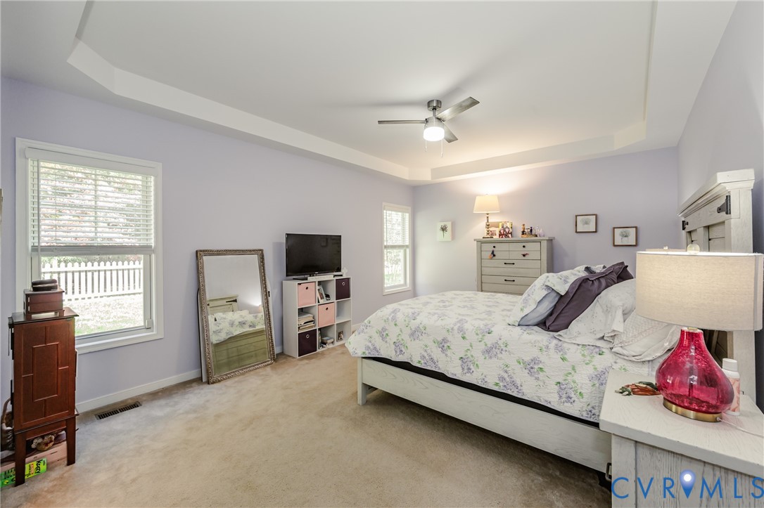 1113 Alcorn Terrace Midlothian, VA 23114 - Photo 31 of 44 a bedroom with a bed and a flat tv screen on dresser