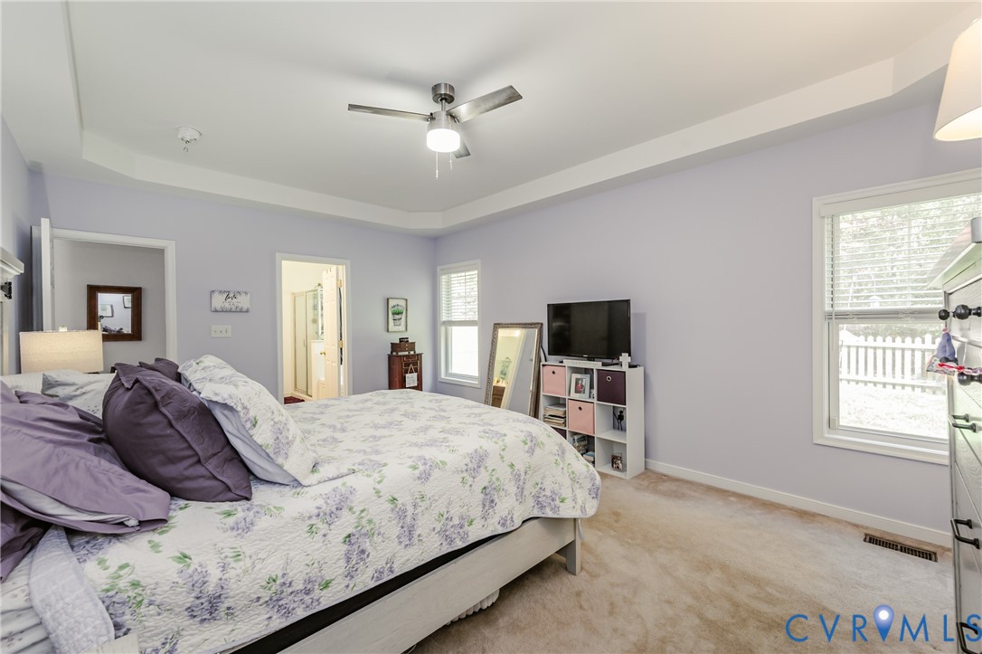 1113 Alcorn Terrace Midlothian, VA 23114 - Photo 33 of 44 a bedroom with a large bed a flat tv screen and a dresser
