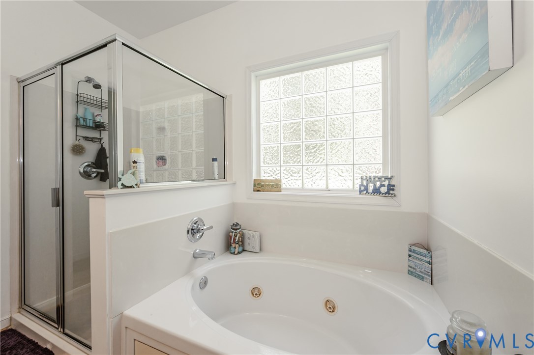 1113 Alcorn Terrace Midlothian, VA 23114 - Photo 34 of 44 a white bath tub sitting next to a white sink and a mirror