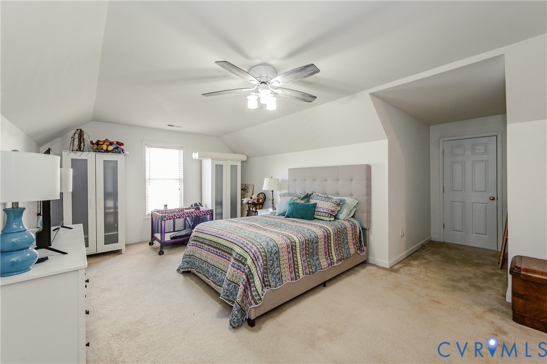 1113 Alcorn Terrace Midlothian, VA 23114 - Photo 38 of 44 a bedroom with a bed chandelier and a window