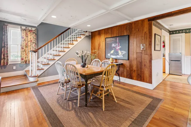 a view of a dining room with furniture window and wooden floor