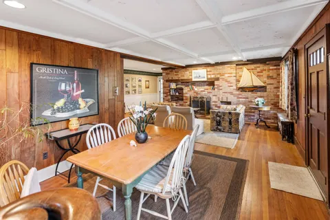 a view of a dining room with furniture wooden floor and chandelier