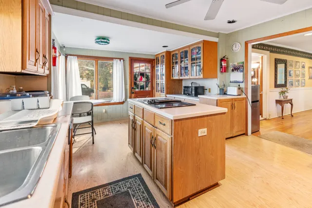 a open kitchen with stainless steel appliances granite countertop a stove and a refrigerator