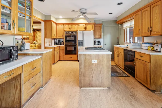 a kitchen with stove a sink and refrigerator