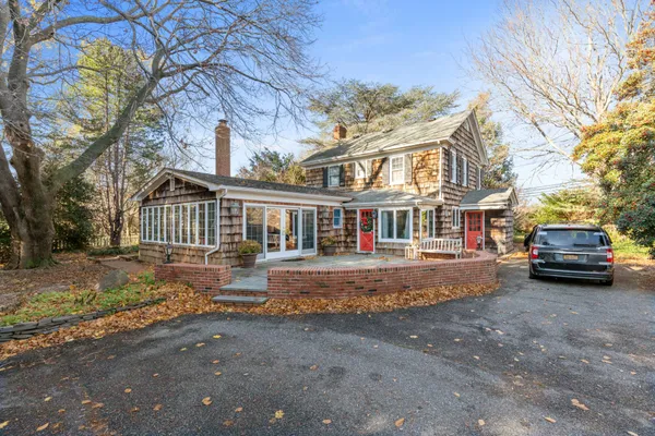 a front view of a house with a garden