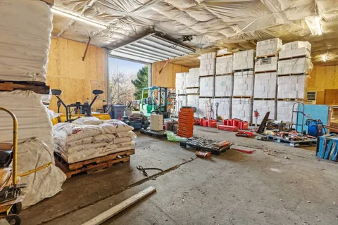 a backyard of a house with barbeque oven table and chairs