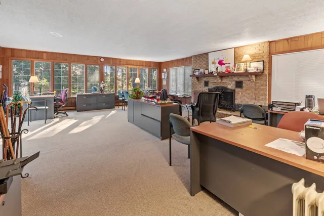 a living room with furniture a large window and a flat screen tv