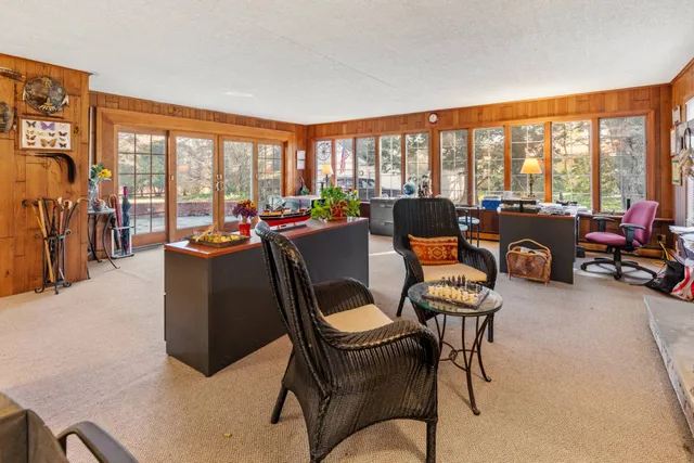 a living room with furniture and large windows