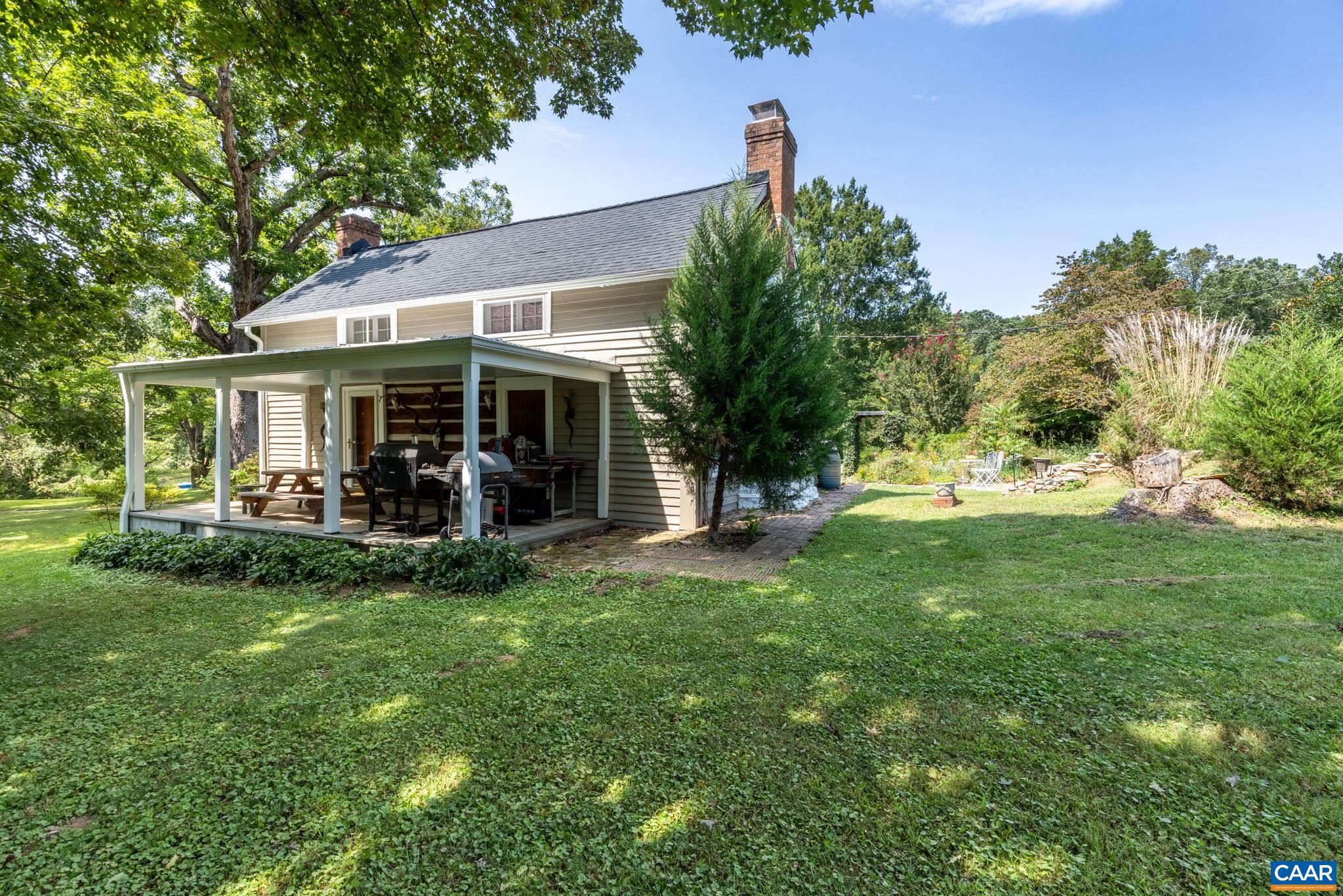 1128 Beaverdam Road Keswick, VA 22947 - Photo 19 of 74 a view of a house with a yard porch and sitting area