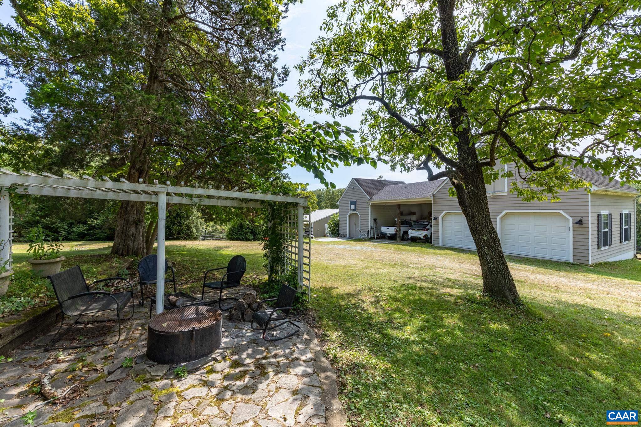 1128 Beaverdam Road Keswick, VA 22947 - Photo 20 of 74 a view of a garden with plants and a barbeque