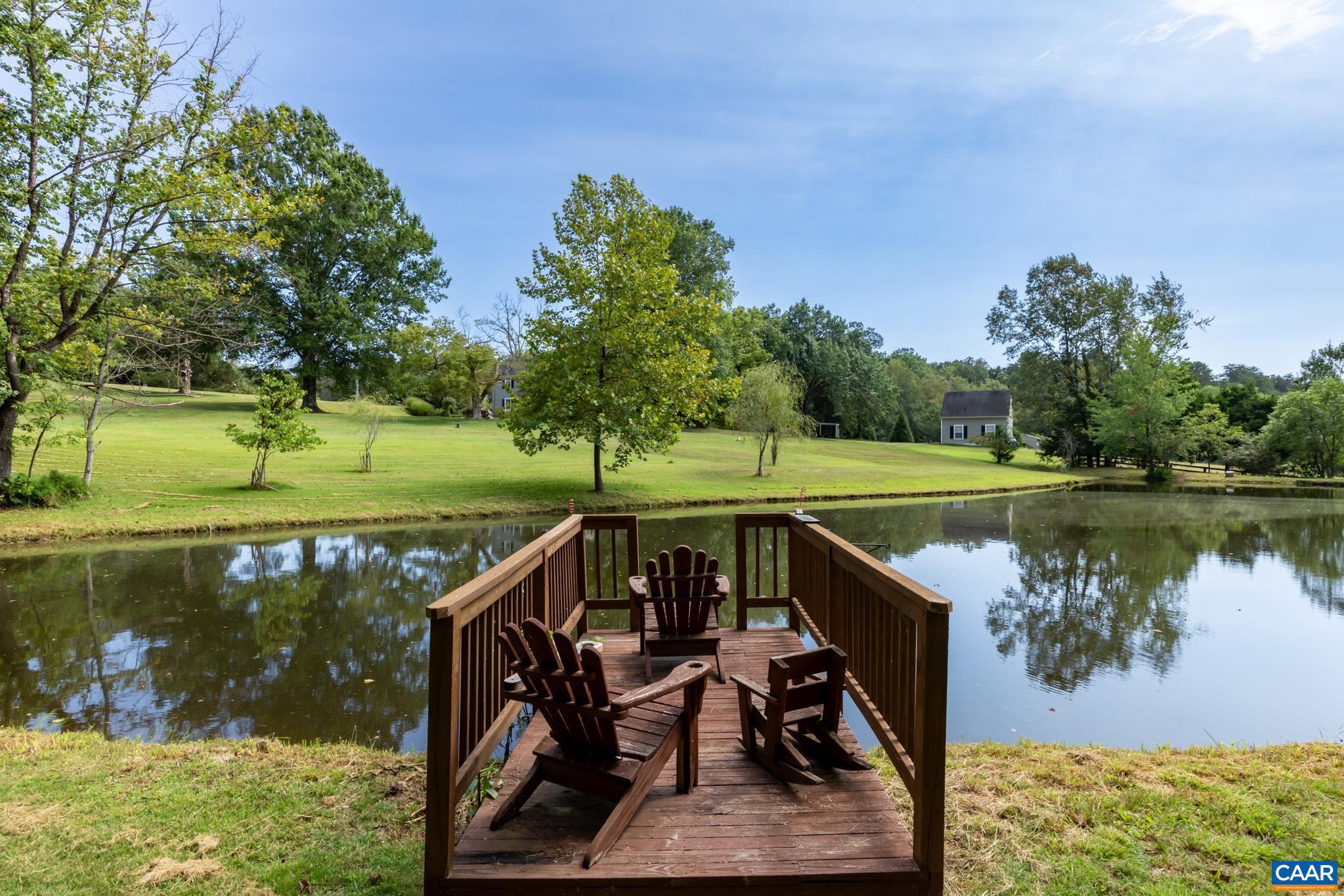 1128 Beaverdam Road Keswick, VA 22947 - Photo 21 of 74 a view of a wooden deck with lake view