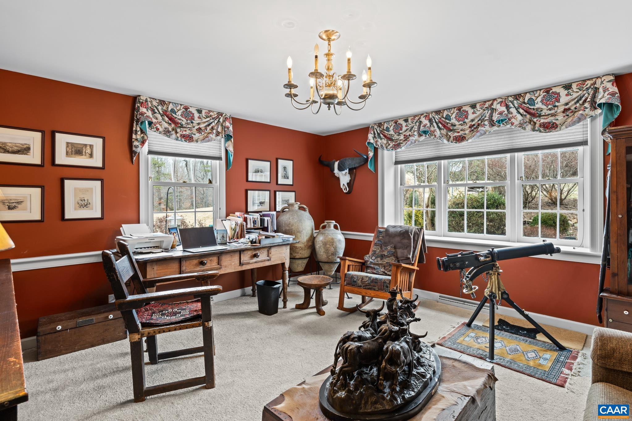 1128 Beaverdam Road Keswick, VA 22947 - Photo 35 of 74 a living room with furniture a chandelier and a large window