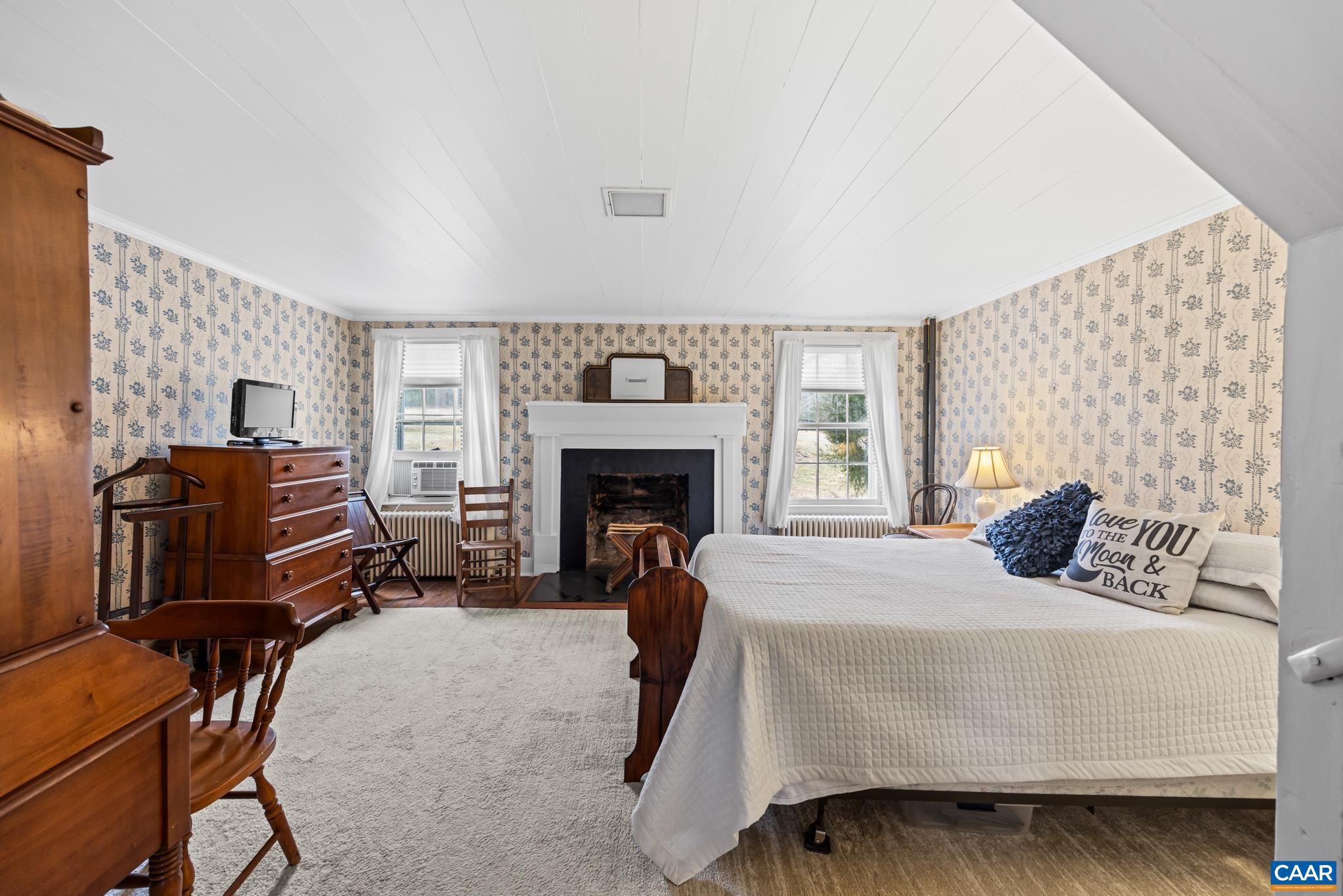 1128 Beaverdam Road Keswick, VA 22947 - Photo 51 of 74 a bedroom with a bed chair and fireplace