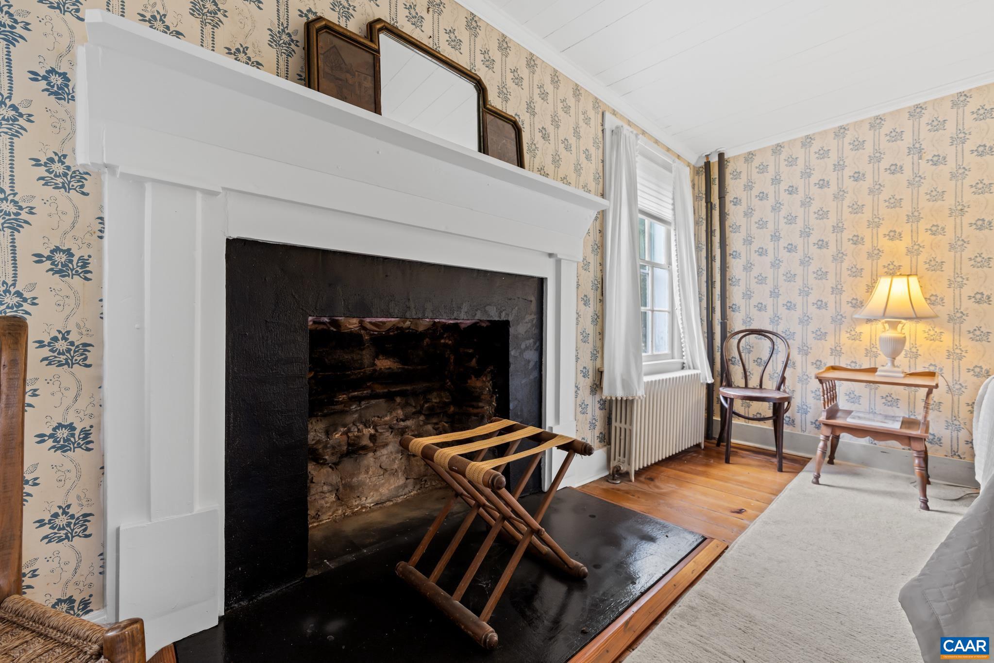 1128 Beaverdam Road Keswick, VA 22947 - Photo 53 of 74 a living room with furniture a dining table and a fireplace