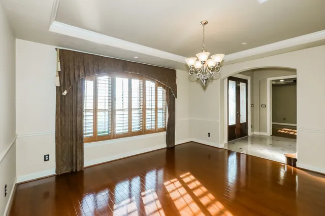 a view of a room with a window and chandelier