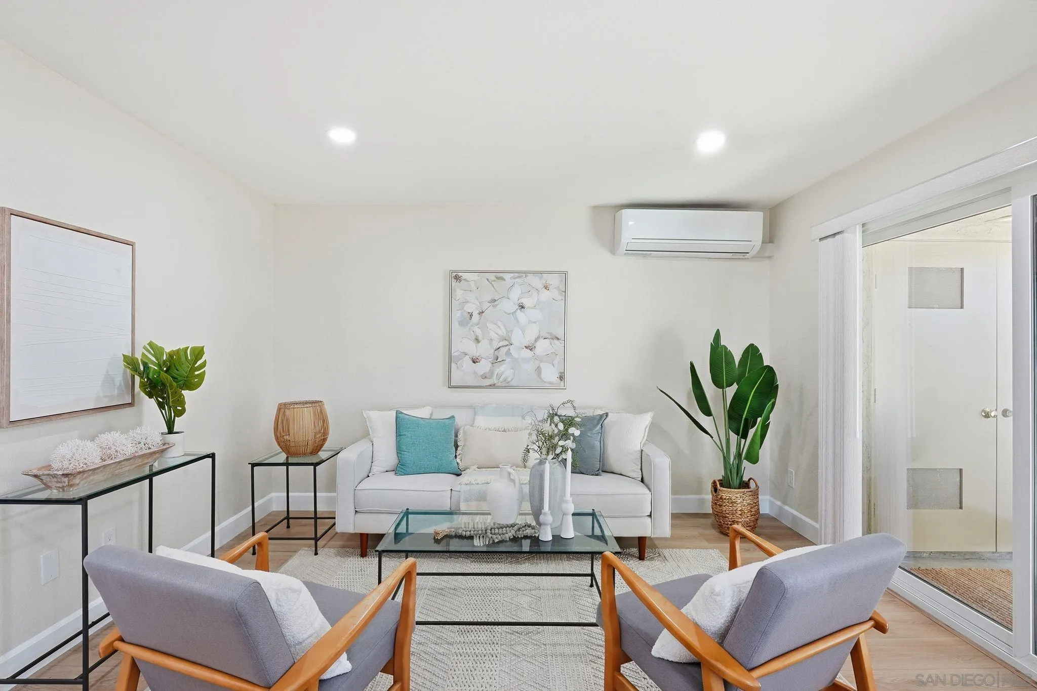 8480 New Salem Street, Unit 103 San Diego, CA 92126 - Photo 1 of 29 a living room with furniture and a potted plant