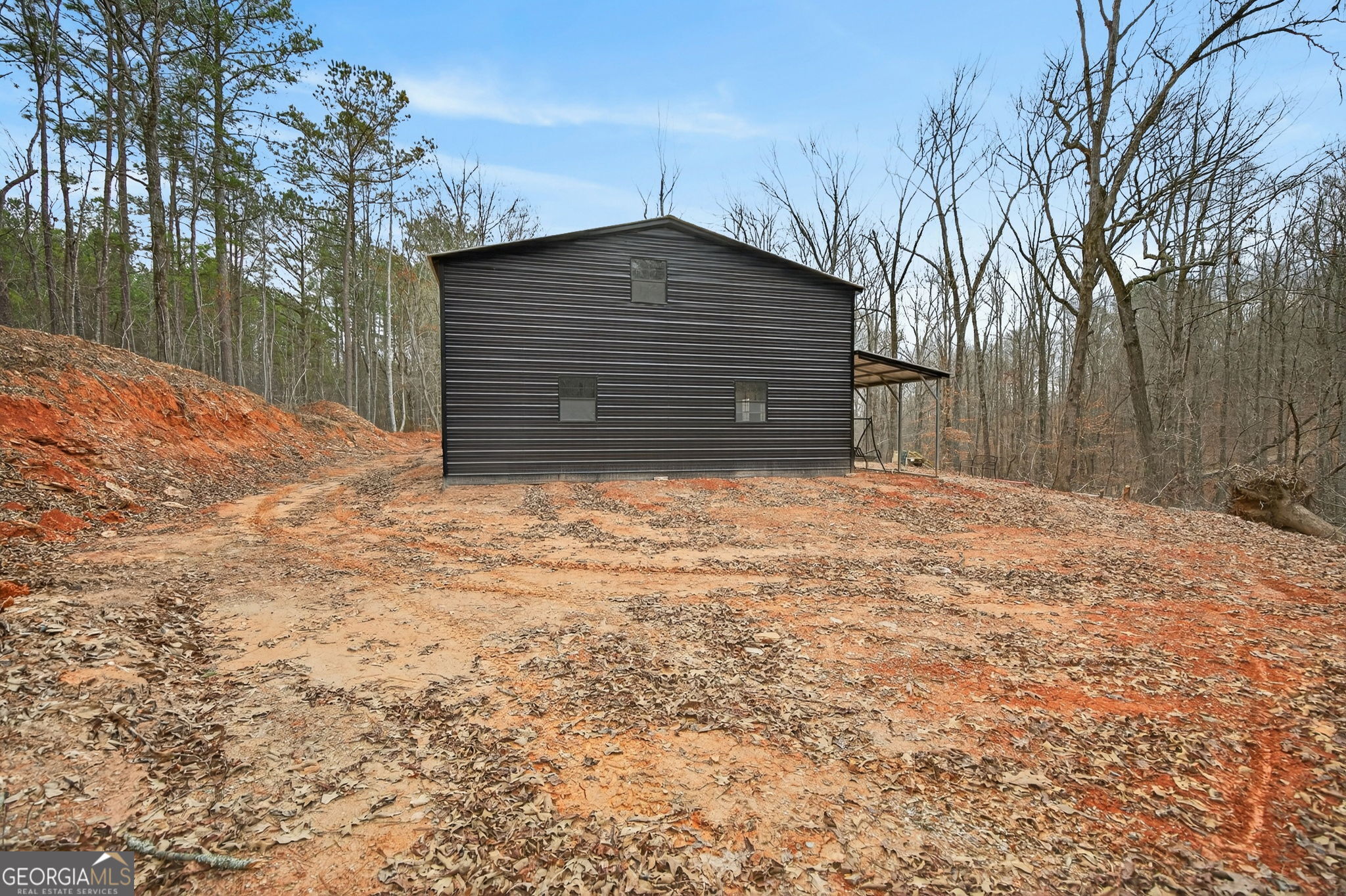 Tract 1 County Road 408 Heflin, AL 36264 - Photo 3 of 21 a house with a yard covered with snow in front of it