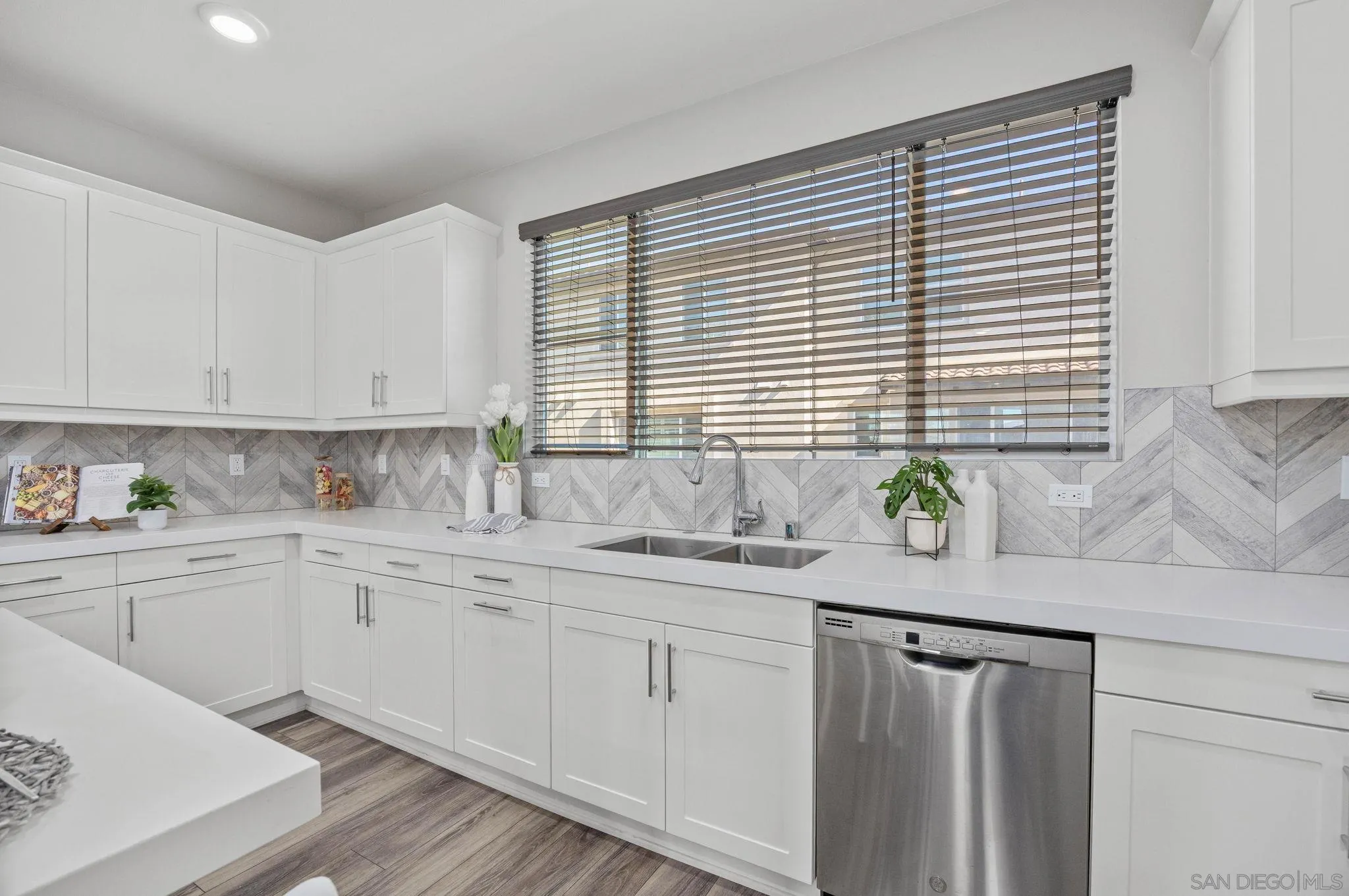 3574 Conner Way Oceanside, CA 92056 - Photo 11 of 52 a kitchen with granite countertop white cabinets white appliances a sink and a window