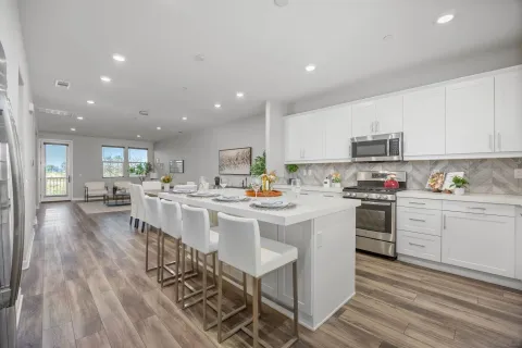 a kitchen with stainless steel appliances kitchen island granite countertop a sink and cabinets