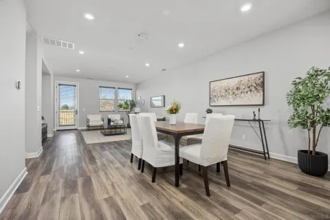 a view of a dining room with furniture and wooden floor