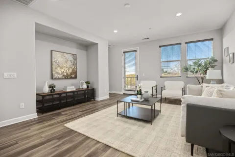 a living room with furniture windows and a flat screen tv