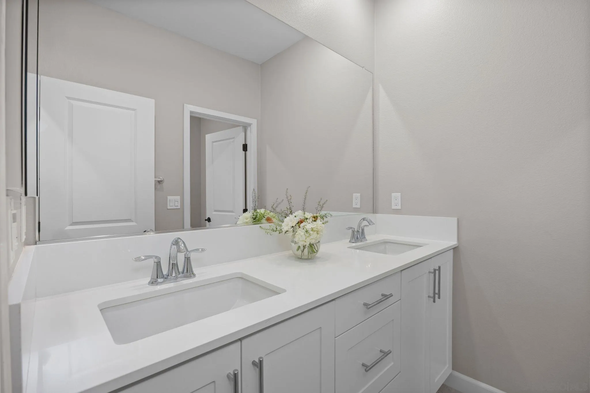 3574 Conner Way Oceanside, CA 92056 - Photo 25 of 52 a bathroom with double sink and a mirror