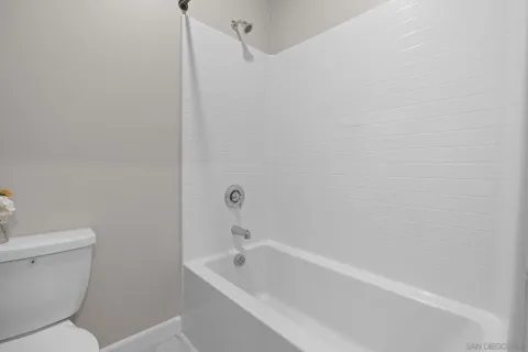 a bathroom with a toilet and bathtub